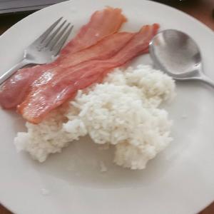 Poorly cooked bacon and leftover rice